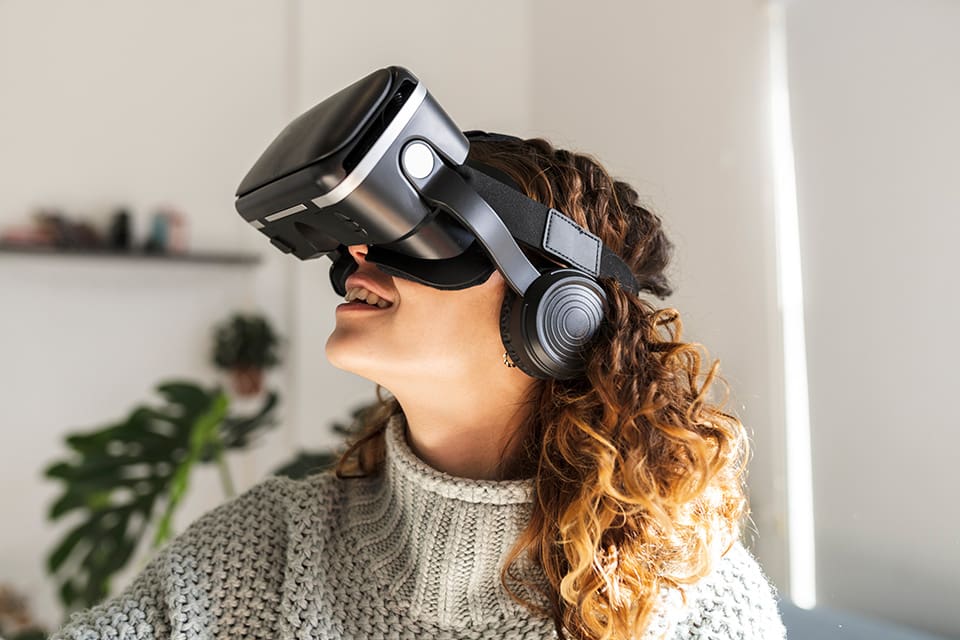 woman taking a virtual tour on a VR headset for an immersive viewing